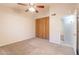 A comfortable bedroom featuring carpet, large closet, ceiling fan and a doorway that leads to the rest of the home at 31 W Loma Vista Dr # 102, Tempe, AZ 85282