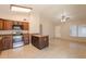 Well-equipped kitchen featuring dark wood cabinets, granite countertops, stainless steel appliances, and tile floors at 31 W Loma Vista Dr # 102, Tempe, AZ 85282