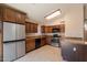Well-appointed kitchen with stainless steel appliances, granite countertops, dark wood cabinets and tile flooring at 31 W Loma Vista Dr # 102, Tempe, AZ 85282