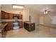 A kitchen featuring dark cabinetry, granite countertops, tile flooring, stainless steel appliances, and an island at 31 W Loma Vista Dr # 102, Tempe, AZ 85282
