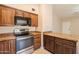 Updated kitchen with stainless steel appliances, granite countertops, and custom wood cabinets at 31 W Loma Vista Dr # 102, Tempe, AZ 85282
