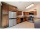Modern kitchen with stainless steel appliances, granite countertops, and dark wood cabinetry with tile flooring at 31 W Loma Vista Dr # 102, Tempe, AZ 85282
