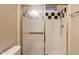 Shower featuring glass doors, unique black and white tile accents and chrome shower head at 31 W Loma Vista Dr # 102, Tempe, AZ 85282