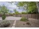 Spacious backyard featuring desert landscaping, a stone patio, and mature trees at 3721 W Aracely Dr, New River, AZ 85087