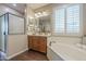Bathroom boasting wood floors, soaker tub, glass shower, and vanity with neutral countertops at 3721 W Aracely Dr, New River, AZ 85087