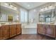 Elegant bathroom with dual sinks, a soaking tub, and stylish fixtures at 3721 W Aracely Dr, New River, AZ 85087