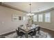 Dining room filled with natural light, featuring an elegant chandelier and modern decor at 3721 W Aracely Dr, New River, AZ 85087