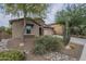 Attractive front exterior with desert landscaping, including lush plantings, a stone accent wall, and a view of the garage at 3721 W Aracely Dr, New River, AZ 85087
