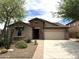 Charming single-story home featuring a stone facade, two-car garage, and desert landscaping at 3721 W Aracely Dr, New River, AZ 85087