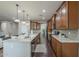 Open concept kitchen with spacious counters, sleek appliances, and dark wood floors at 3721 W Aracely Dr, New River, AZ 85087