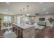 Bright open-concept kitchen with large island next to the dining and living area at 3721 W Aracely Dr, New River, AZ 85087