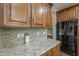 Close-up of the kitchen's counters, backsplash, and appliances at 3721 W Aracely Dr, New River, AZ 85087