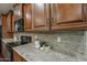 Close-up of the kitchen's counters, backsplash, and appliances at 3721 W Aracely Dr, New River, AZ 85087