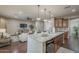 Open-concept kitchen island with granite countertops overlooks the adjacent living area at 3721 W Aracely Dr, New River, AZ 85087