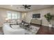 Comfortable living room boasting hardwood floors, a ceiling fan, a television, and an inviting seating arrangement at 3721 W Aracely Dr, New River, AZ 85087
