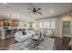 Open living space with hardwood floors, ceiling fan, ample natural light, and seamless flow to the kitchen and dining area at 3721 W Aracely Dr, New River, AZ 85087