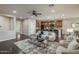 Spacious living room featuring dark wood floors, contemporary furnishings, a ceiling fan, and an open layout at 3721 W Aracely Dr, New River, AZ 85087