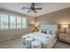 Inviting bedroom featuring a ceiling fan, natural light, and plush furnishings at 3721 W Aracely Dr, New River, AZ 85087