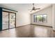 Spacious bedroom featuring tile floors, a ceiling fan, a sliding door, and a large window at 3740 W Kent Dr, Chandler, AZ 85226