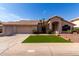 Single-story home showcasing desert landscaping, manicured lawn, and a spacious three-car garage at 3740 W Kent Dr, Chandler, AZ 85226