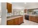 Kitchen with wood cabinets, tile floors, and a view into the breakfast nook and backyard at 3740 W Kent Dr, Chandler, AZ 85226