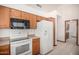 Bright kitchen with white appliances, wooden cabinets, and tile flooring at 3740 W Kent Dr, Chandler, AZ 85226