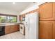 Well-lit kitchen featuring white appliances, tile floors, and wooden cabinets at 3740 W Kent Dr, Chandler, AZ 85226