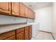 Spacious laundry room with ample cabinet space and a modern washer and dryer at 3740 W Kent Dr, Chandler, AZ 85226