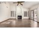 Open-concept living room boasting vaulted ceilings, a fireplace, and wood-look tile flooring at 3740 W Kent Dr, Chandler, AZ 85226