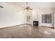 Bright living room with high ceilings, a ceiling fan, fireplace, and wood-look tile floors at 3740 W Kent Dr, Chandler, AZ 85226
