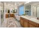 Bright bathroom featuring dual vanities, a soaking tub, and a glass-enclosed shower at 3741 E Ember Glow Way, Phoenix, AZ 85050