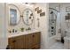 Bathroom with dual sinks, framed mirrors, and shower/tub combo with white tile surround at 3741 E Ember Glow Way, Phoenix, AZ 85050