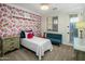 Floral bedroom featuring natural light, a bed, and sofa at 3741 E Ember Glow Way, Phoenix, AZ 85050
