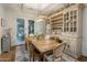 Traditional dining room features a wooden table, chairs, and a built-in cabinet with glass doors and wine storage at 3741 E Ember Glow Way, Phoenix, AZ 85050