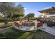 Outdoor fire pit area with seating and surrounding greenery, perfect for social gatherings and relaxation at 3741 E Ember Glow Way, Phoenix, AZ 85050