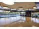 Bright fitness center with hardwood floors and floor-to-ceiling windows overlooking the outdoor pool at 3741 E Ember Glow Way, Phoenix, AZ 85050