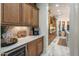 This kitchen features custom cabinets, marble countertops, a wine cooler, and recessed lighting throughout at 3741 E Ember Glow Way, Phoenix, AZ 85050