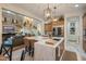 Spacious kitchen featuring a large center island with sink and view to the living room at 3741 E Ember Glow Way, Phoenix, AZ 85050