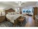 This bedroom features a king-sized bed, elegant decor, and a workout area with natural lighting and hardwood floors at 3741 E Ember Glow Way, Phoenix, AZ 85050