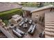 Aerial view of an outdoor living space with a fireplace, seating, lighting, and lush landscaping at 3741 E Ember Glow Way, Phoenix, AZ 85050