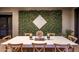Elegant patio with a long dining table and decorative greenery wall at 3741 E Ember Glow Way, Phoenix, AZ 85050