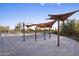 Relaxing pool area with shade structures, lounge chairs, and well-maintained landscaping for outdoor enjoyment at 3741 E Ember Glow Way, Phoenix, AZ 85050