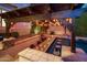 Outdoor pool bar featuring a stone countertop and seating, lit by decorative lights at 3741 E Ember Glow Way, Phoenix, AZ 85050
