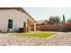 Beautiful backyard featuring a patch of green turf surrounded by rock at 3756 E Alamo St, San Tan Valley, AZ 85140