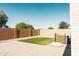 The backyard has a patch of green turf surrounded by brick pavers and rocks at 3756 E Alamo St, San Tan Valley, AZ 85140