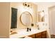 Stylishly designed bathroom featuring a round mirror and attractive lighting fixtures at 3756 E Alamo St, San Tan Valley, AZ 85140