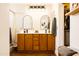 Bathroom featuring a double sink vanity, modern lighting, arched mirrors, and a glass enclosed shower at 3756 E Alamo St, San Tan Valley, AZ 85140