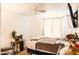 Bedroom featuring wood floors, white walls, a ceiling fan, and a platform bed with a gray comforter at 3756 E Alamo St, San Tan Valley, AZ 85140