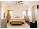 Bright bedroom featuring wood floors, white walls, a ceiling fan, and two matching nightstands at 3756 E Alamo St, San Tan Valley, AZ 85140