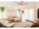 Bright and inviting living room boasts neutral decor, soft lighting, and cozy seating arrangements at 3756 E Alamo St, San Tan Valley, AZ 85140